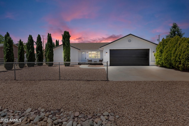 ranch-style house with a garage, concrete driveway, stucco siding, and fence