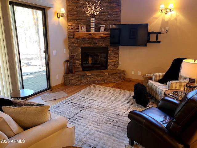 2978 Timberline Rd, Pinetop, AZ 85935 - living area featuring baseboards, a stone fireplace, and wood finished floors