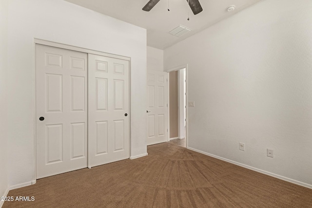 unfurnished bedroom featuring baseboards, a closet, visible vents, and carpet flooring