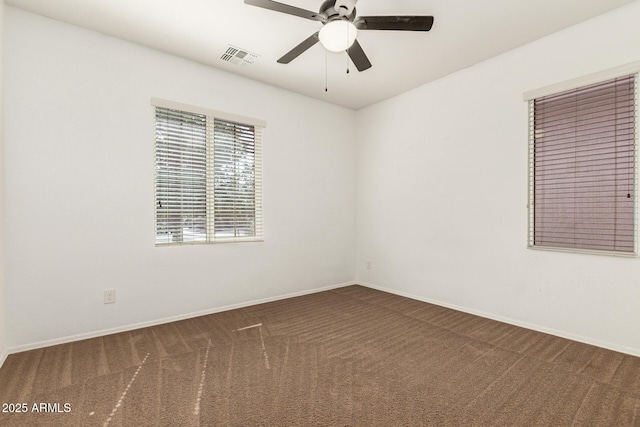 empty room featuring a ceiling fan, baseboards, visible vents, and carpet flooring