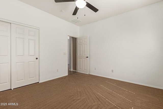 unfurnished bedroom featuring carpet floors, a closet, visible vents, and baseboards