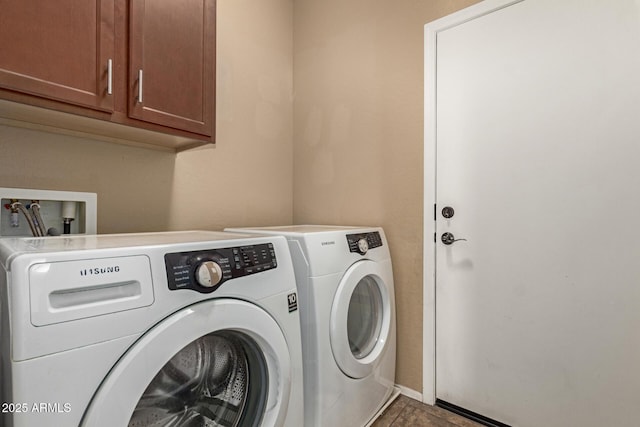 washroom featuring cabinet space and washing machine and dryer