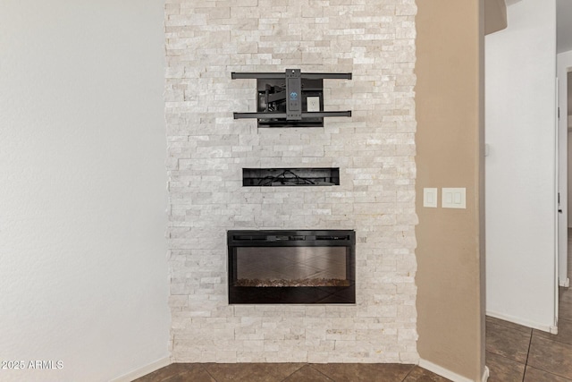 interior details featuring a fireplace and baseboards