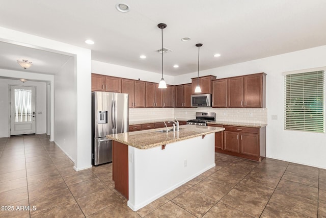 kitchen featuring light stone counters, a breakfast bar, stainless steel appliances, backsplash, and a sink