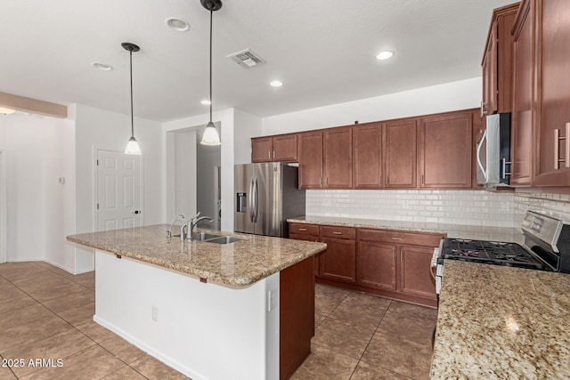 kitchen featuring visible vents, brown cabinets, a sink, stainless steel appliances, and backsplash