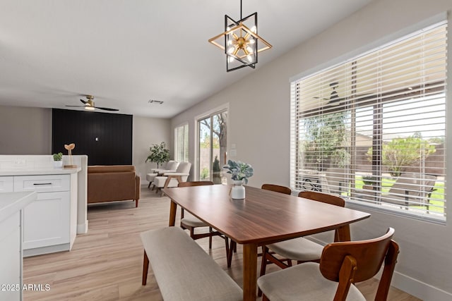 33287 N Windmill Run, San Tan Valley, AZ 85144 - dining space with a ceiling fan, light wood finished floors, baseboards, and a chandelier