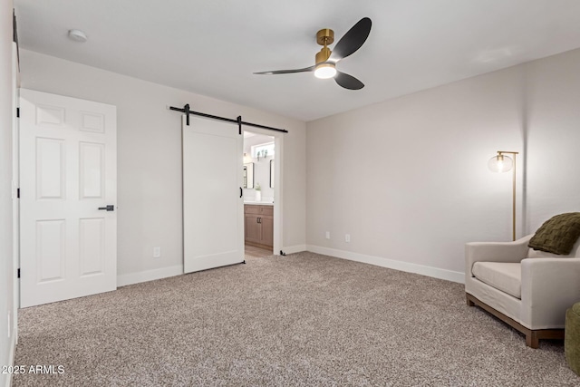 33287 N Windmill Run, San Tan Valley, AZ 85144 - unfurnished bedroom with a barn door, light carpet, baseboards, and connected bathroom