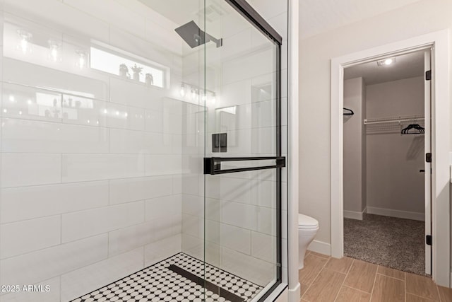 33287 N Windmill Run, San Tan Valley, AZ 85144 - full bathroom with a shower stall, a spacious closet, toilet, and baseboards