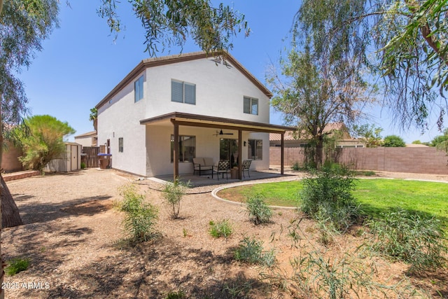 33287 N Windmill Run, San Tan Valley, AZ 85144 - back of house with a ceiling fan, a fenced backyard, stucco siding, and a patio area