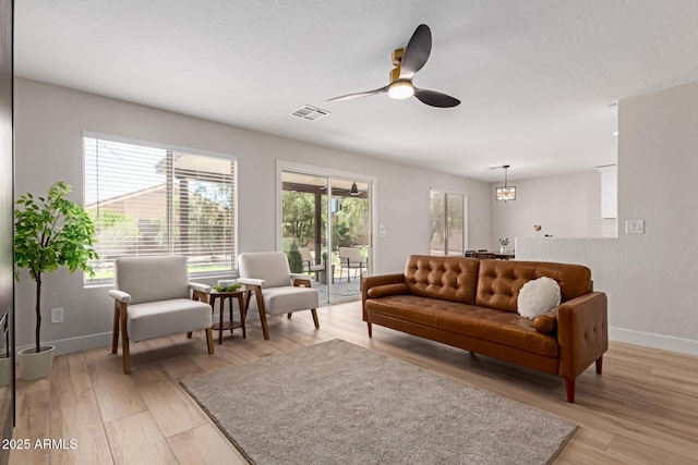 33287 N Windmill Run, San Tan Valley, AZ 85144 - living room with baseboards, a ceiling fan, and light wood-type flooring