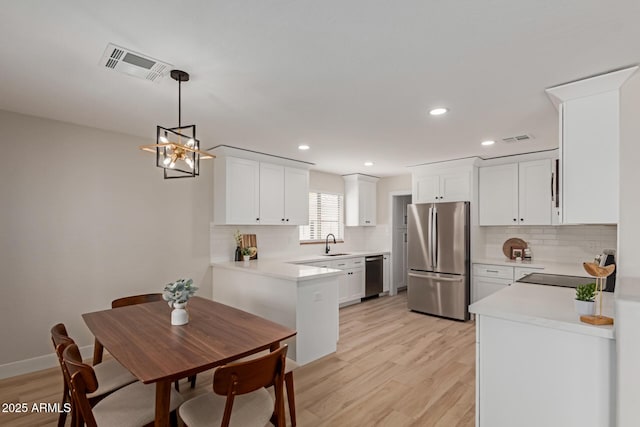 33287 N Windmill Run, San Tan Valley, AZ 85144 - kitchen featuring appliances with stainless steel finishes, light wood-style floors, backsplash, light countertops, and recessed lighting