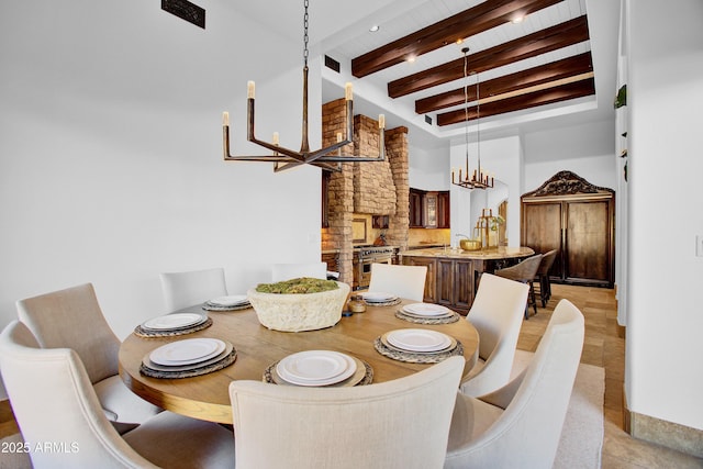 dining area with a chandelier and beam ceiling