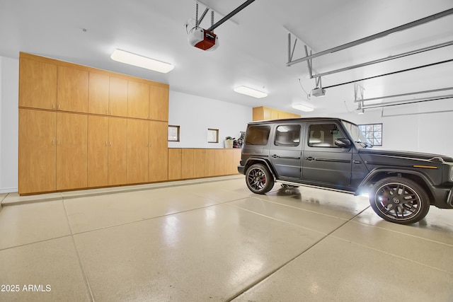 garage featuring a wainscoted wall and a garage door opener