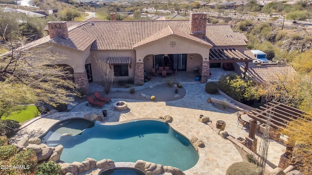 view of pool featuring a pool with connected hot tub and a patio