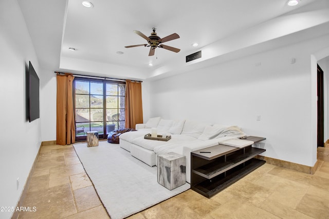 living area featuring stone tile floors, visible vents, baseboards, and recessed lighting