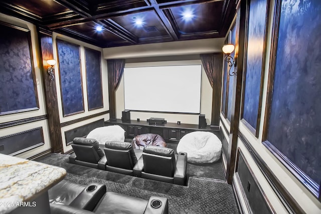 carpeted cinema with coffered ceiling and beamed ceiling