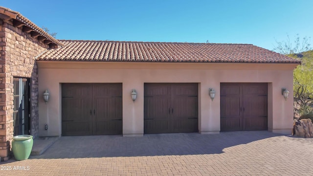 garage with decorative driveway