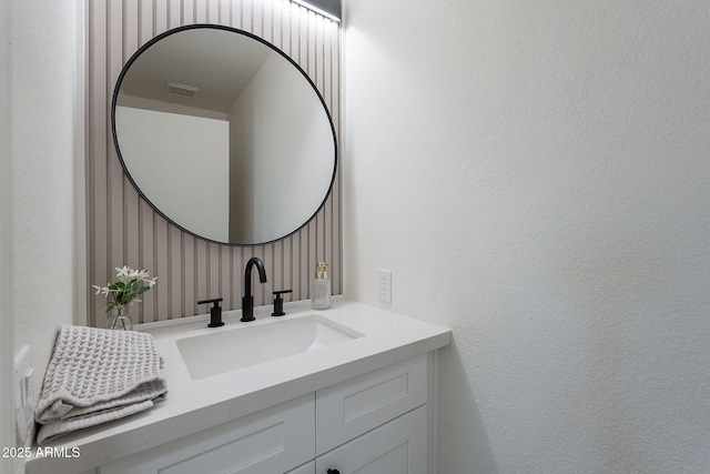 bathroom featuring vanity and visible vents