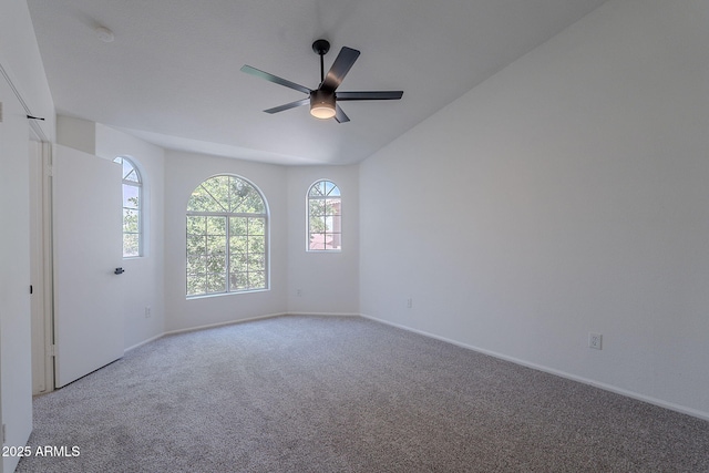 unfurnished room with light carpet, baseboards, lofted ceiling, and ceiling fan