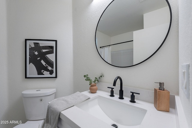 bathroom with toilet and vanity