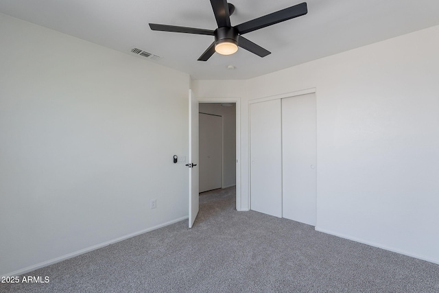 unfurnished bedroom with a closet, visible vents, ceiling fan, light carpet, and baseboards
