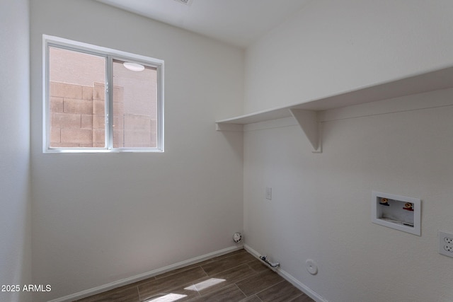 laundry area with wood tiled floor, baseboards, gas dryer hookup, washer hookup, and laundry area