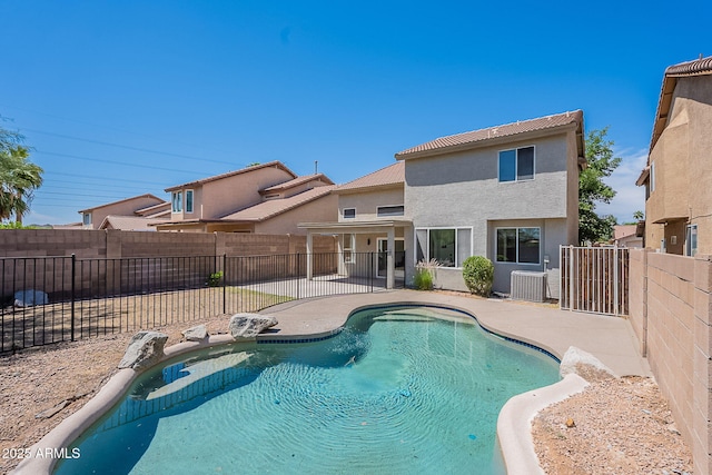 view of pool with a patio area, cooling unit, a fenced in pool, and a fenced backyard