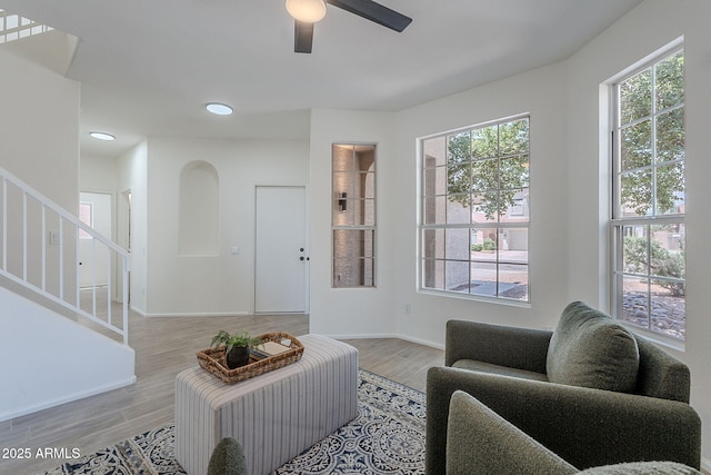 living area featuring recessed lighting, stairway, ceiling fan, light wood finished floors, and baseboards