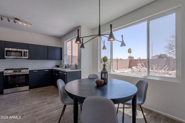 dining space featuring baseboards and wood finished floors