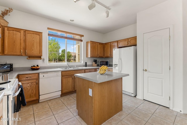 7790 E Bravo Ln, Prescott Valley, AZ 86314 - kitchen featuring white appliances, light tile patterned floors, a kitchen island, light countertops, and rail lighting