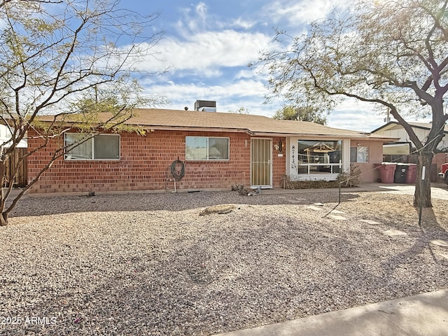 ranch-style home featuring brick siding