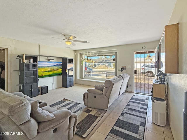 tiled living room with a textured ceiling and ceiling fan