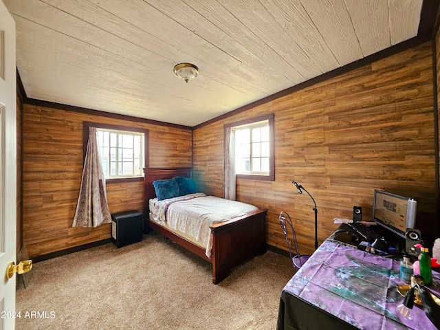 carpeted bedroom with wood walls, wooden ceiling, and multiple windows