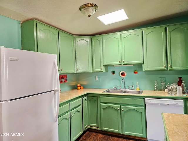 kitchen with dark hardwood / wood-style flooring, white appliances, sink, and green cabinetry