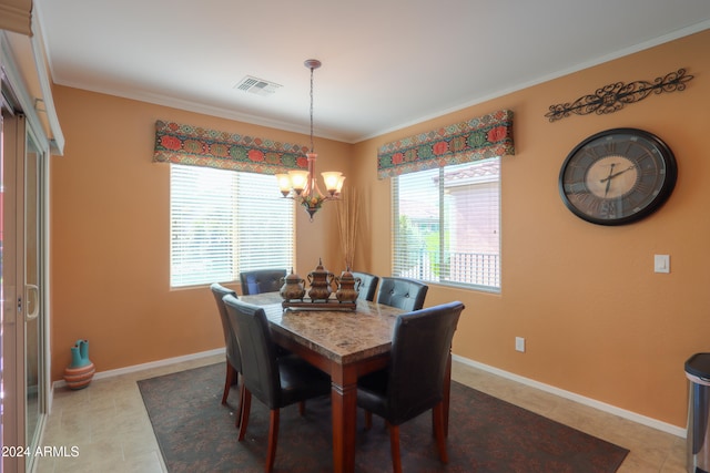 tiled dining space with crown molding and a notable chandelier