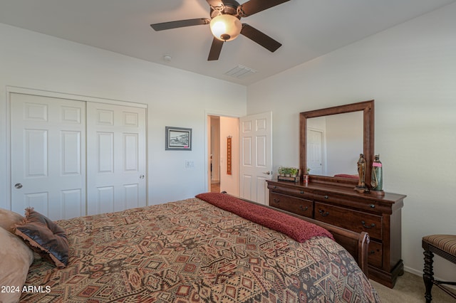 carpeted bedroom featuring a closet and ceiling fan