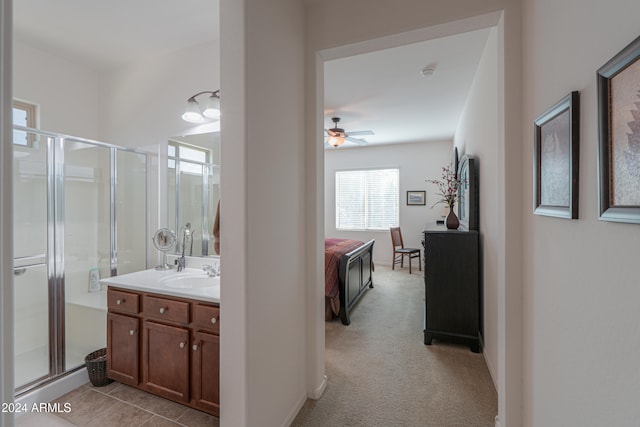 bathroom featuring vanity, walk in shower, and ceiling fan