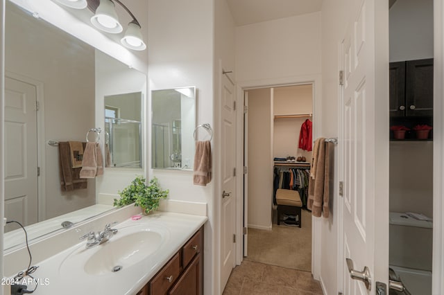 bathroom with vanity, tile patterned floors, and an enclosed shower