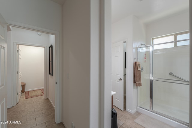 bathroom featuring a shower with door and tile patterned floors