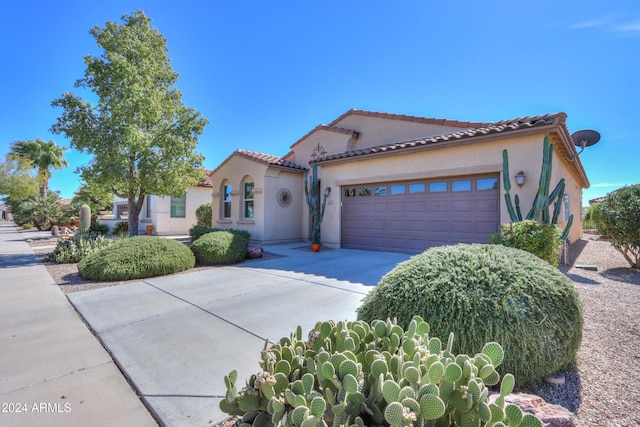 mediterranean / spanish-style home featuring a garage