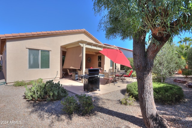 rear view of property featuring a patio area