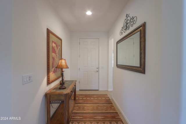 hallway with hardwood / wood-style floors