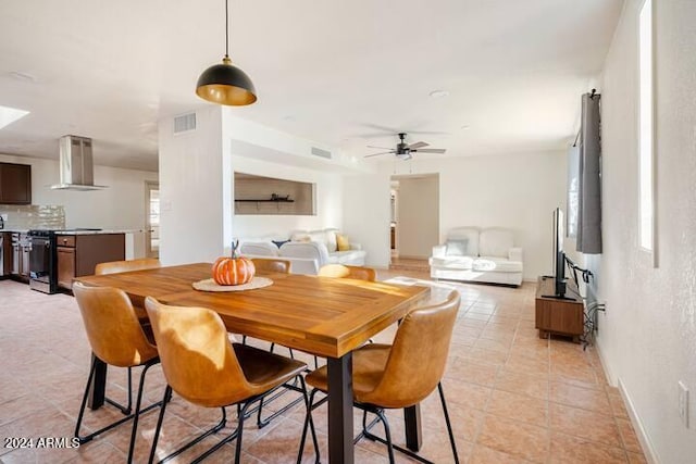 tiled dining space featuring ceiling fan