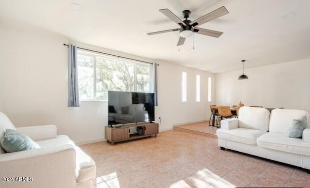 tiled living room with ceiling fan