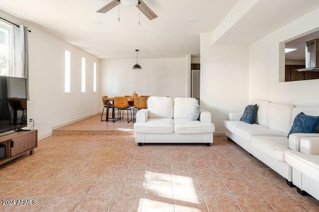 tiled living room with ceiling fan