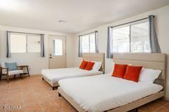 bedroom with tile patterned floors and multiple windows