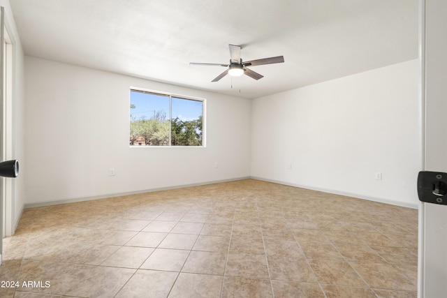 empty room with light tile patterned floors and ceiling fan