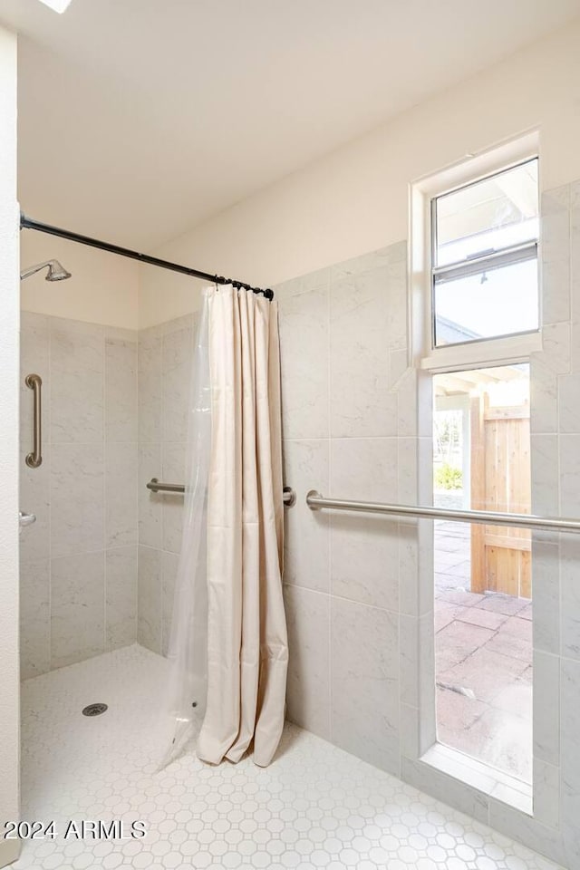 bathroom featuring curtained shower and a healthy amount of sunlight