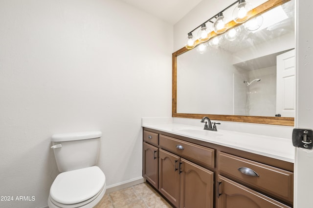 bathroom featuring tile patterned flooring, vanity, and toilet