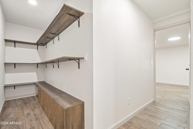 spacious closet featuring light hardwood / wood-style floors